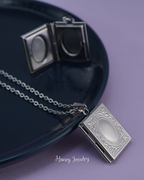 Book locket necklace with border
